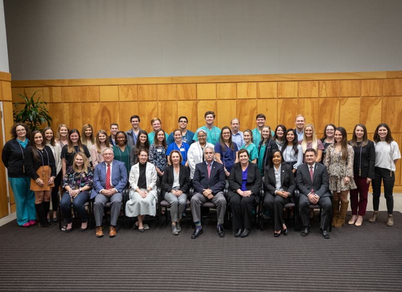 Among those receiving honors at the Phi Kappa Phi induction ceremony are, front row from left, Elisabeth Rachel McAuliffe; Dr. Ralph Didlake, associate vice chancellor for academic affairs and chief academic officer; Dr. Sydney Murphy, associate dean for academic affairs, SGSHS; Dr. Jessica Bailey, SHRP dean; Dr. David Felton, SOD dean; Dr. Julie Sanford, SON dean; Dr. Bettina Beech, SOPH dean; and Dr. Tony Ammeter, UM Phi Kappa Phi Chapter president; second row from left, Ashley Ramage McClain; Lauren Hope Nuckles; Christian Robertson Fortenberry; Mallory Lee Vance; Mekayla Nichole Rainey; Hannah Catherine Stovall; Lindsey Megan Griffin; Macey Larkin Lee; Leanndra Kerri Griffith; Emily Lauren Hillman; Alexandra Lillian Engel; Justina Ardoin Boles; Jocelyne Olguin; Sallie Gardner Metcalf; Jennifer Leigh Hargett; Madison Renee Jones; Leslie Ann Musshafen; and Abbey Alyssa Broome; and third row from left, Sara Spencer Pace; Kristen Leigh Ellzey; Kaitlyn McKenzi Powell; Samuel Jeffrey Moser; Seth Colton Warren; Marshall Scruggs; Thomas Scott Tubby; Hunter McMinn Hawkins; Ottis Lee Brown Jr.; Jared Michael Akers; Margaret Jeanne Fortenberry; and Andrew Zachary Ketchum.